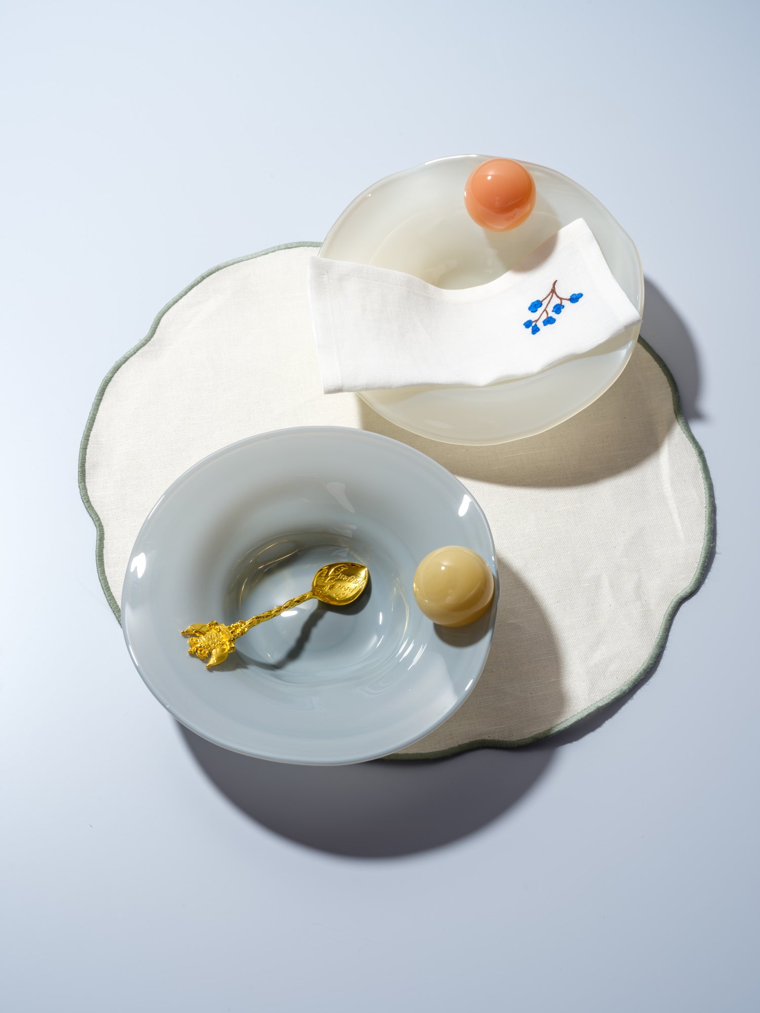 two breakfast bowls with a ball on the side in yellow, blue, orange and white