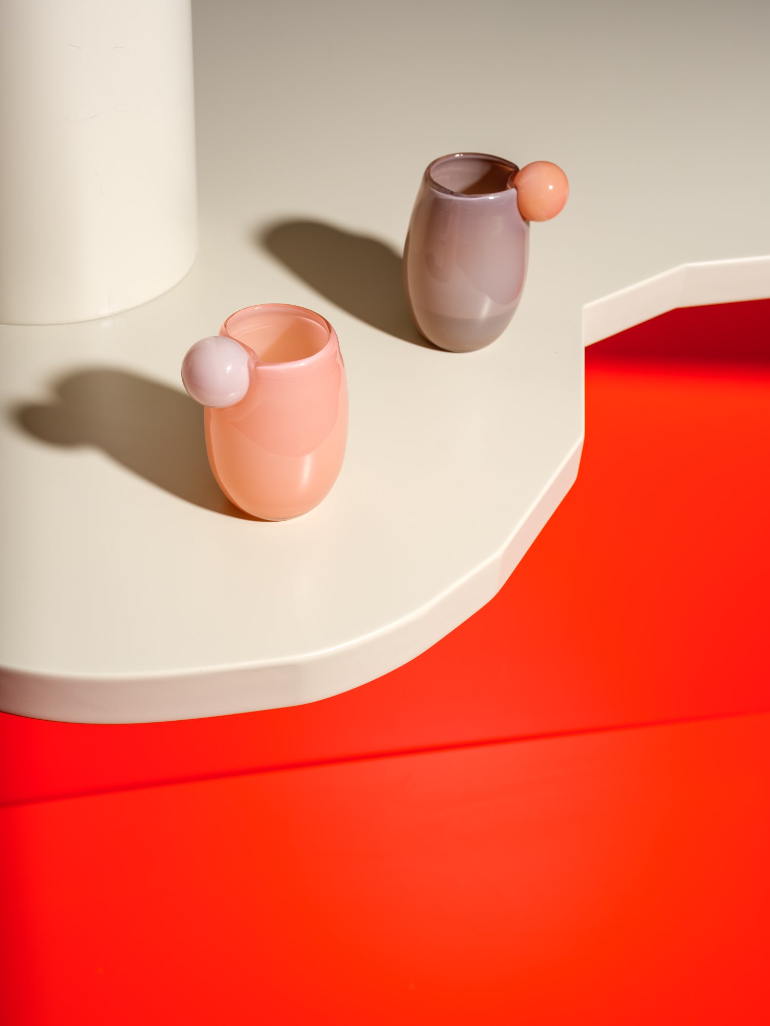 Cup made of glass with a ball on the side in light pink and purple