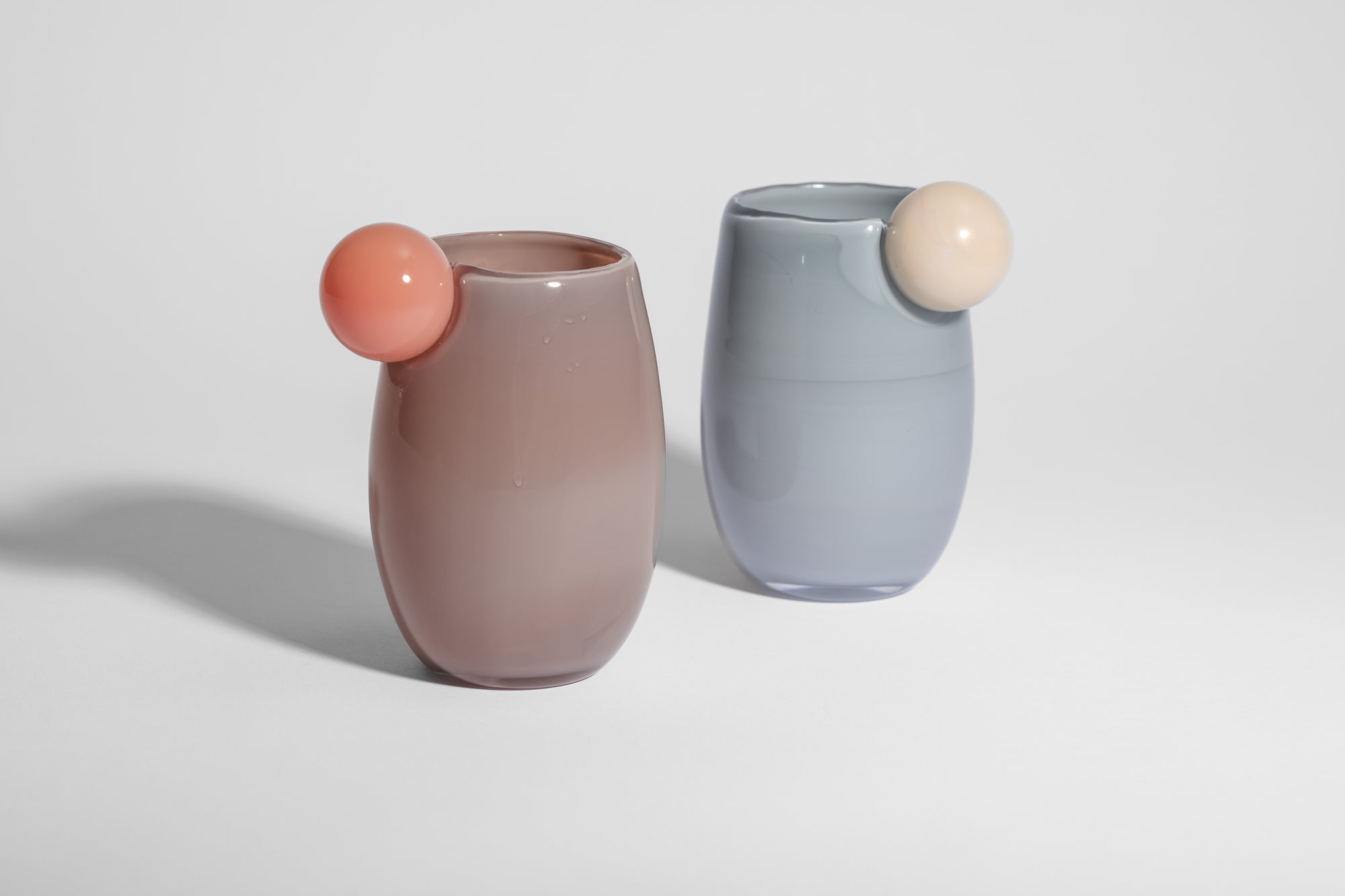 Cup made of glass with a ball on the side in light pink and purple