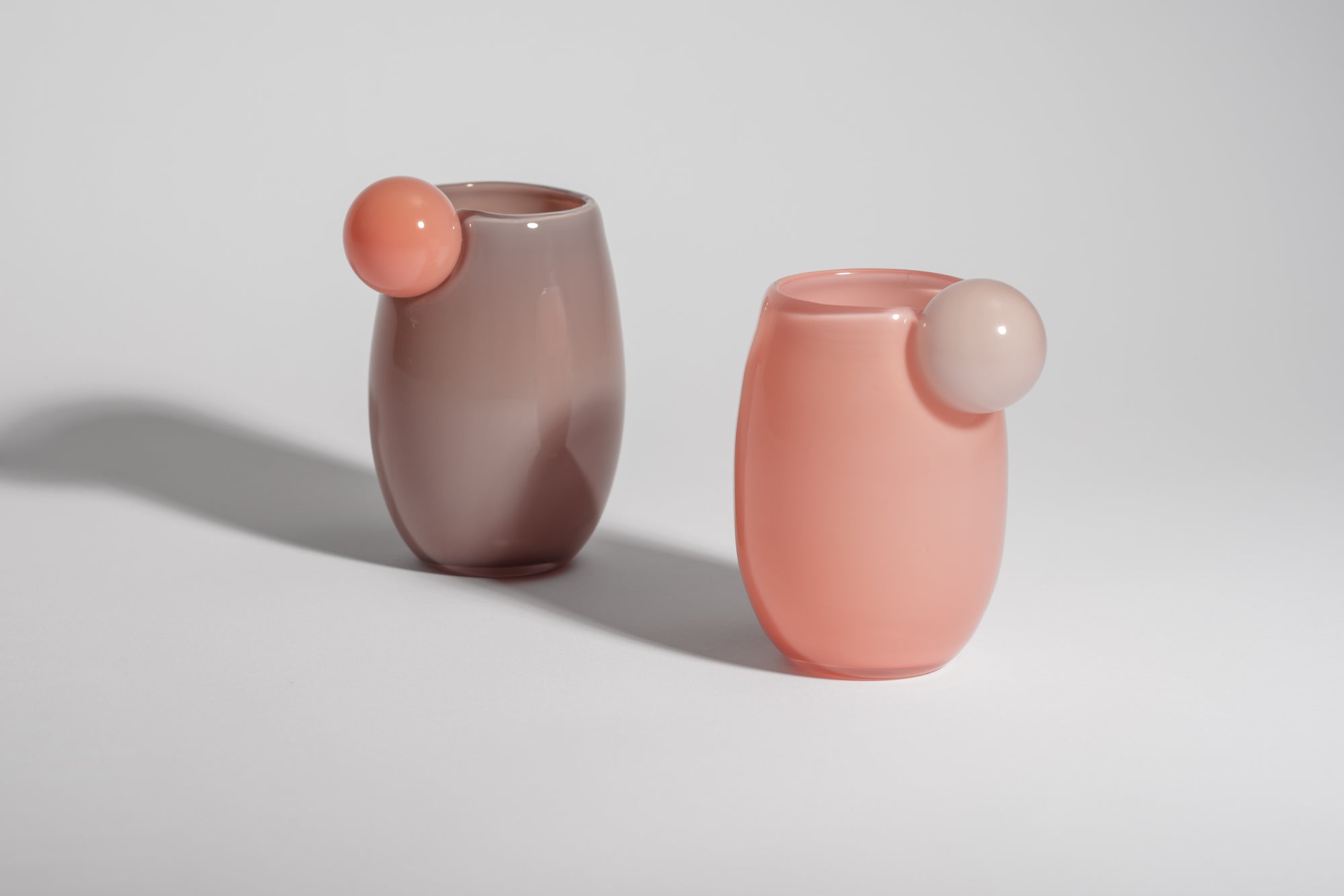 Cup made of glass with a ball on the side in light pink and purple